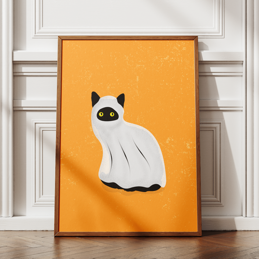 Framed artwork of a white cat with black spots on an orange background, leaning against a wall.