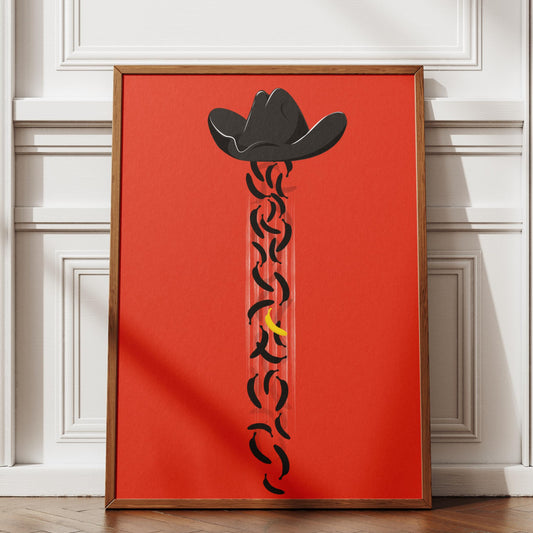 Framed artwork with a cowboy hat design on a red background, displayed in a room with white walls and wooden floor.